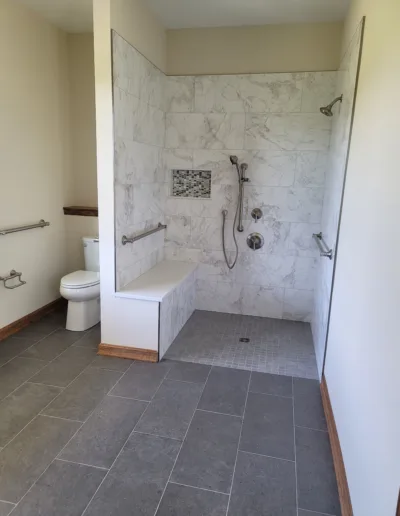 A bathroom with a walk in shower and toilet.