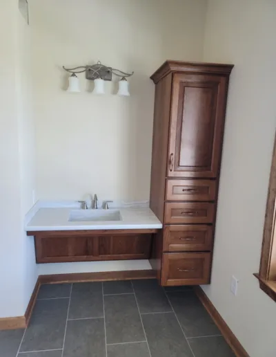 A bathroom with a sink and cabinets.