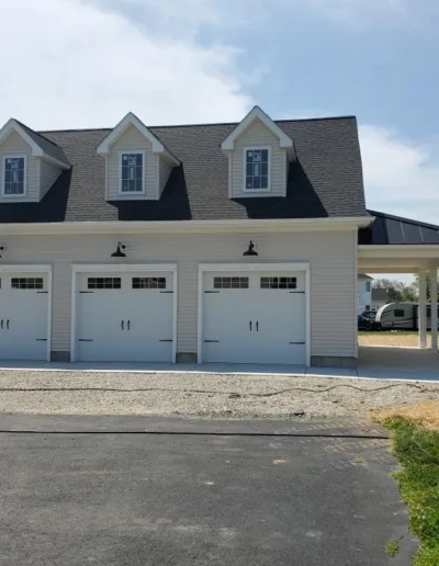 A white garage with two garage doors.