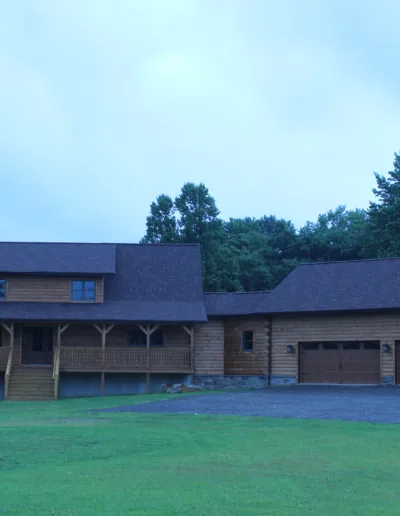 A large log home with a garage.