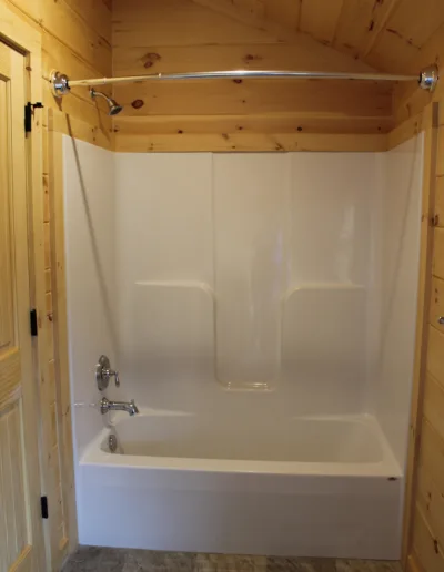 A white bathtub in a cabin bathroom.