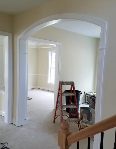 A room that is being remodeled with an archway.