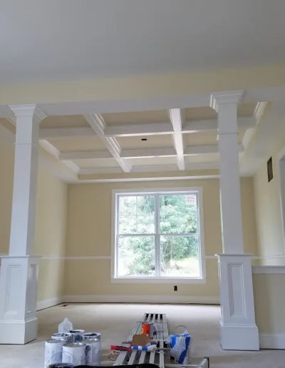 A room is being painted with white walls and white trim.